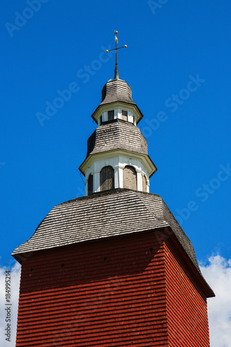 Red bell tower against blue sky