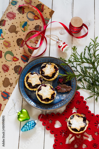 Mincemeat pies. Christmas decorations. Cranberries. White background.