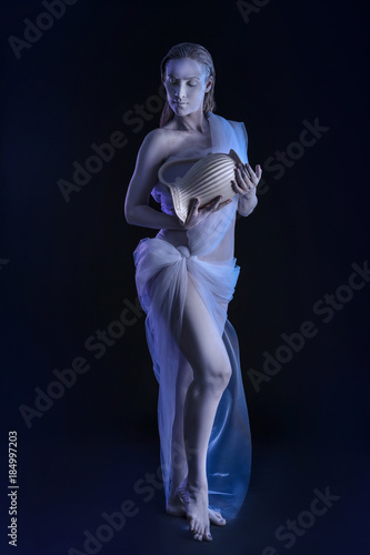 Beautiful young woman with amazing body-art as Aquarius against dark background. Zodiac signs concept