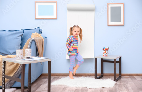 Little cute girl drawing on...