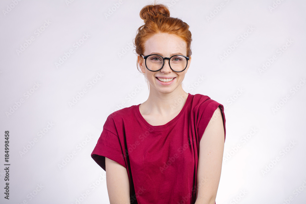 Close up portrait of attractive young redhead woman smiling with glasses
