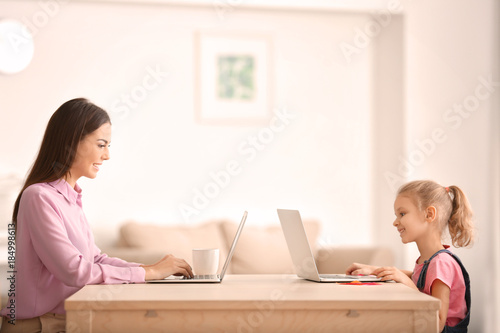 Smiling mother and daughter...