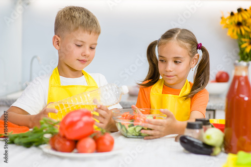 children prepare vegetable salad for lunch