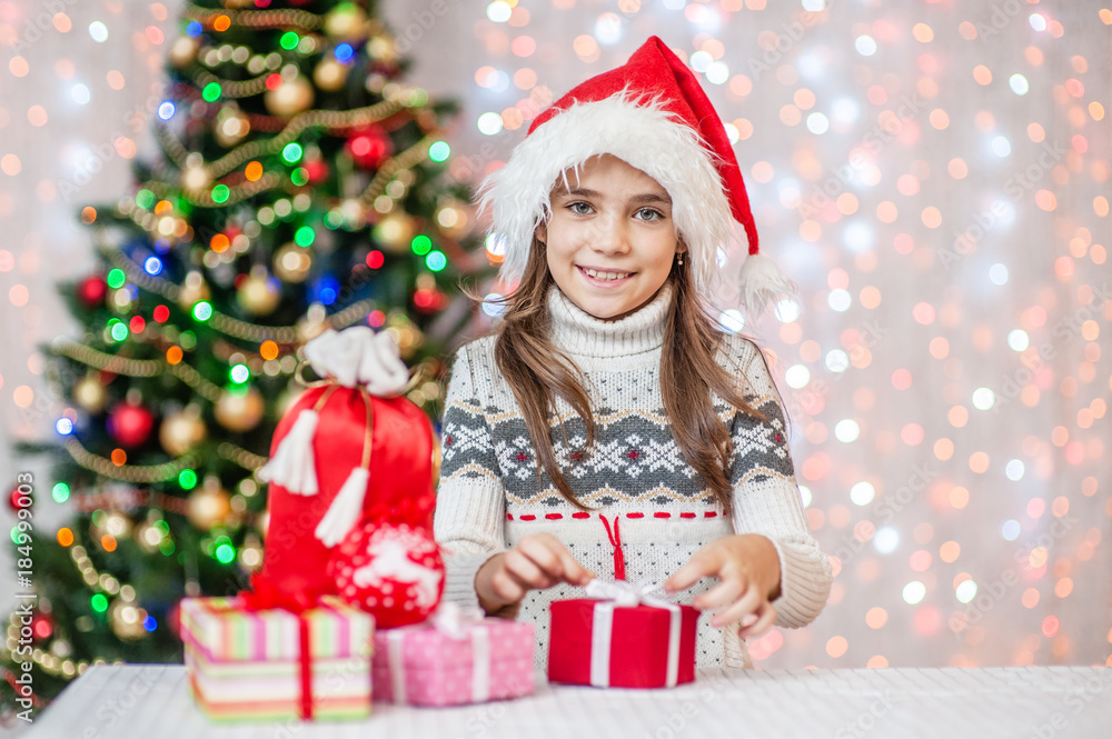 Happy girl is packing a Christmas present Happy girl is packing a Christmas present