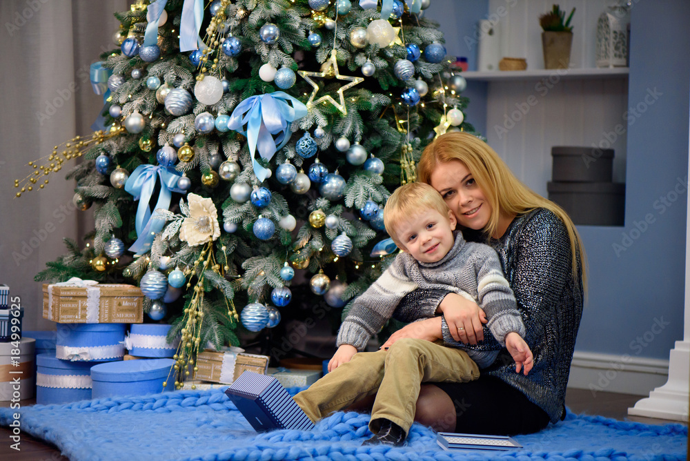 Portrait of happy mother and son celebrate Christmas. New Year's holidays. Portrait of happy mother and son celebrate Christmas. New Year's holidays.