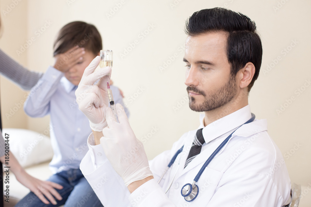 Doctor preparing injection kid at hospital. Kid scary needle when looking doctor hold. People with medical concept. Doctor preparing injection kid at hospital. Kid scary needle when looking doctor hold. People with medical concept.