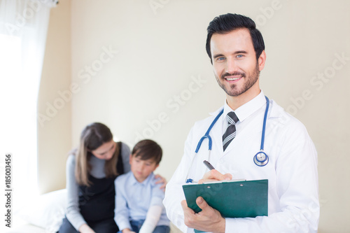 Doctor looking to camera with attractive smiling and patient background. People with medical concept.