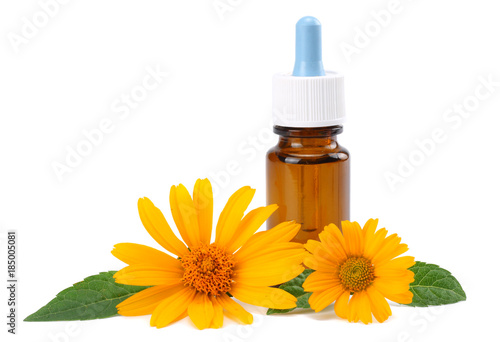 aromatherapy essential oil with marigold flowers isolated on white background