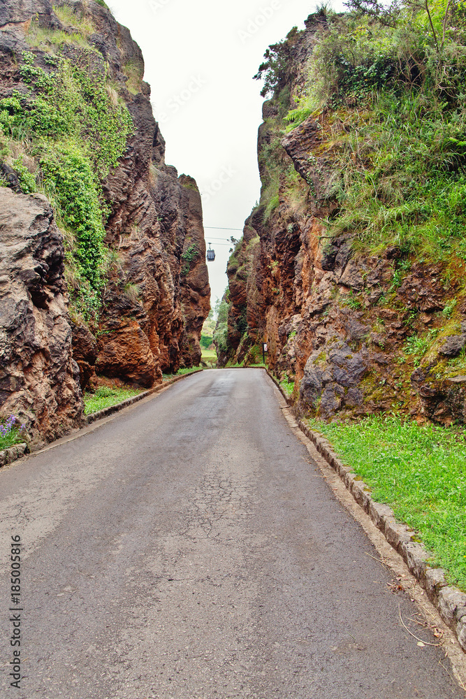 The asphalted road between high rocks.