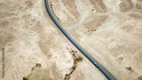 Desert road - Aerial image of a new two lane road surrounded by dry desert landscape