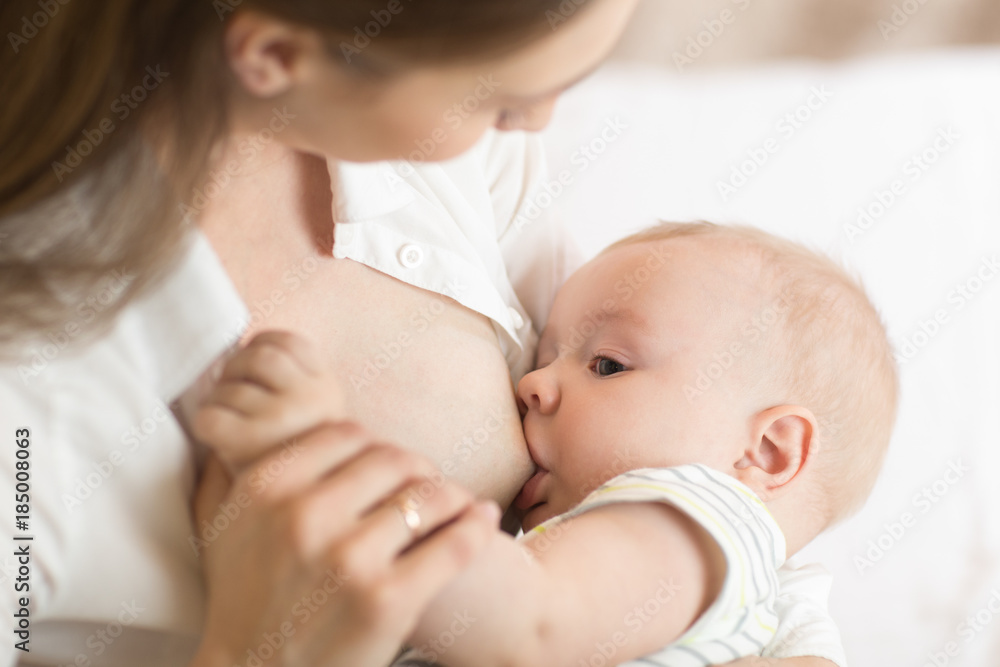 Young mother holding her newborn child. Mom nursing baby. Pretty woman breastfeeding kid. Young mother holding her newborn child. Mom nursing baby. Pretty woman breastfeeding kid.