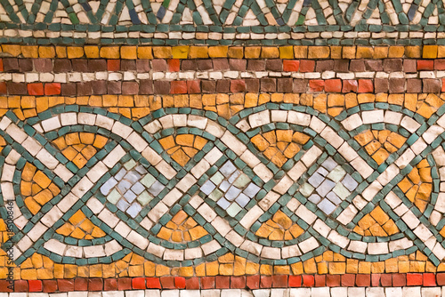 Fragment of ancient mosaic on the wall