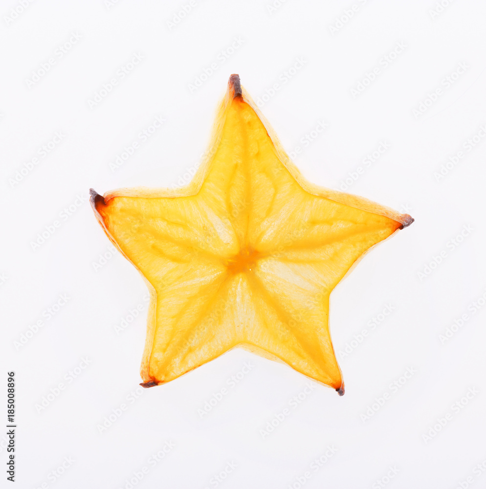 Fototapeta premium Yellow star fruit slice backlit, isolated on white