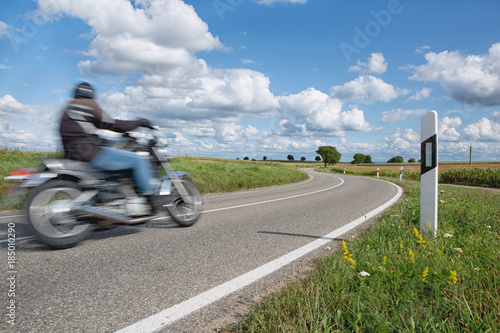 biker rides his bike on curvy road