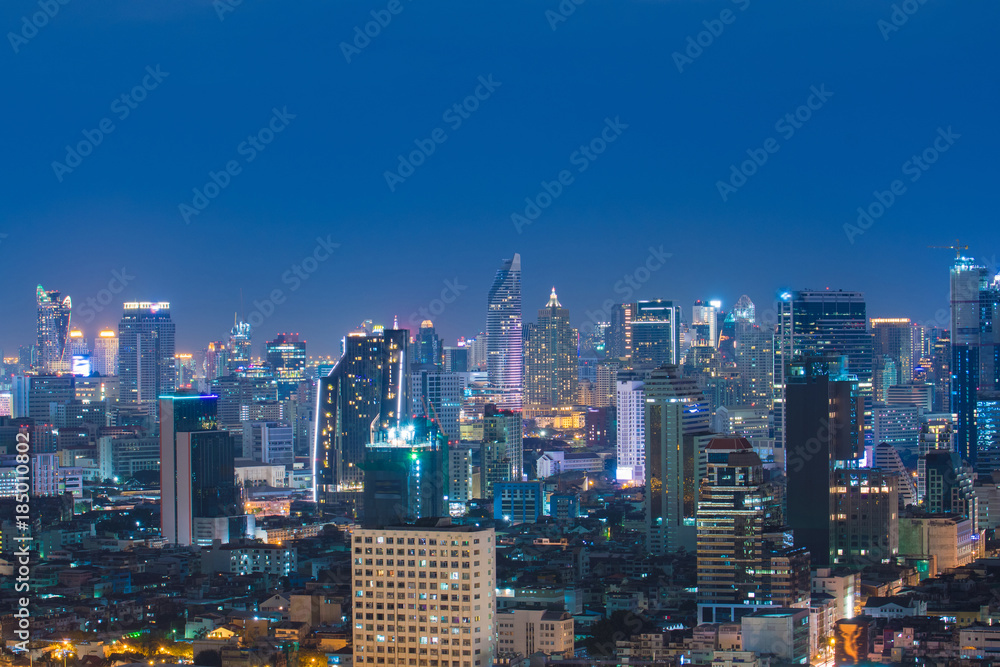 Bangkok city skyline, downtown, business district, hotel, residential building and office building at night.