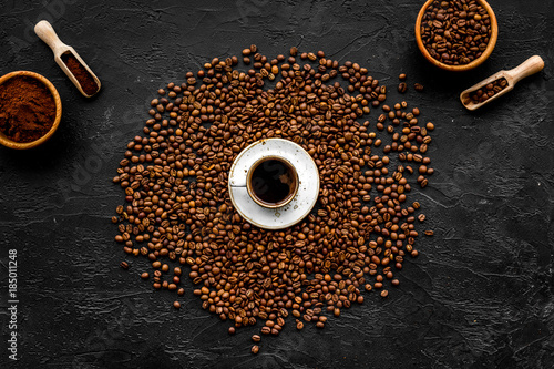 Coffee concept. Roasted beans, ground coffee, cup of espresso on black background top view
