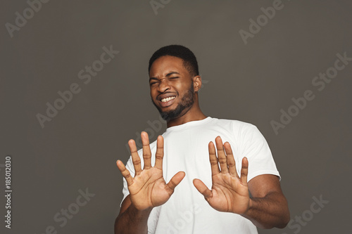Negative human emotion, black man expressing disgust