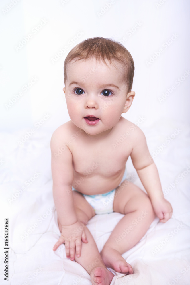 Portrait of a smiling crawling baby on the bed in her room. Space for text Portrait of a smiling crawling baby on the bed in her room. Space for text