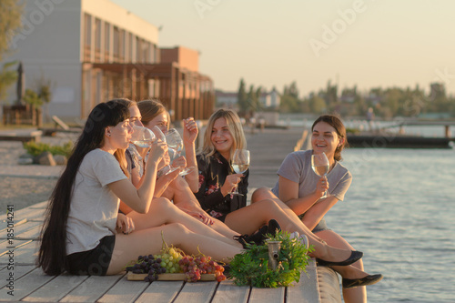 Canvas Print Summer party of young beautiful womans with wine, sea resort relaxing in sunny d