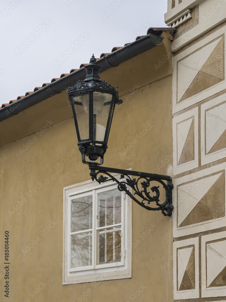close up old street lamp lantern on renassaince palace yellow white facade in prague castle close up old street lamp lantern on renassaince palace yellow white facade in prague castle