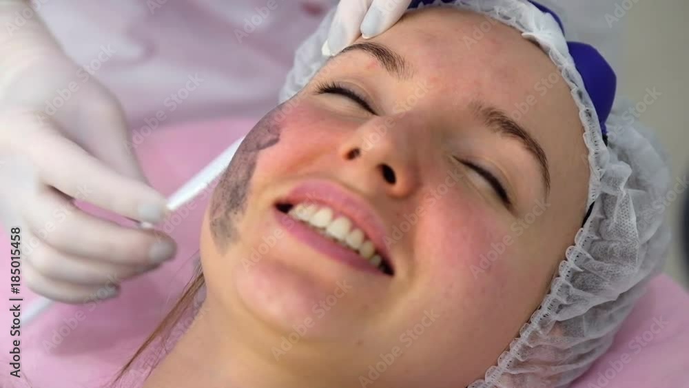 Young woman during the procedure in the clinic of aesthetic cosmetology Young woman during the procedure in the clinic of aesthetic cosmetology