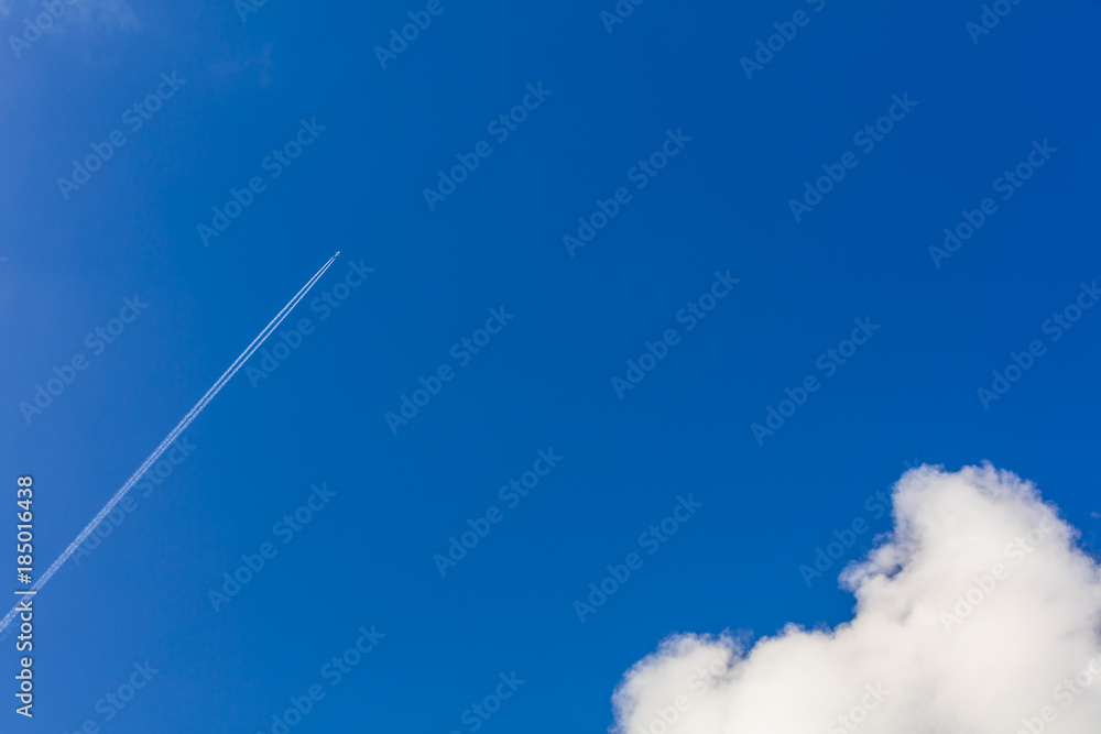 White plane flying high in the blue sky White plane flying high in the blue sky