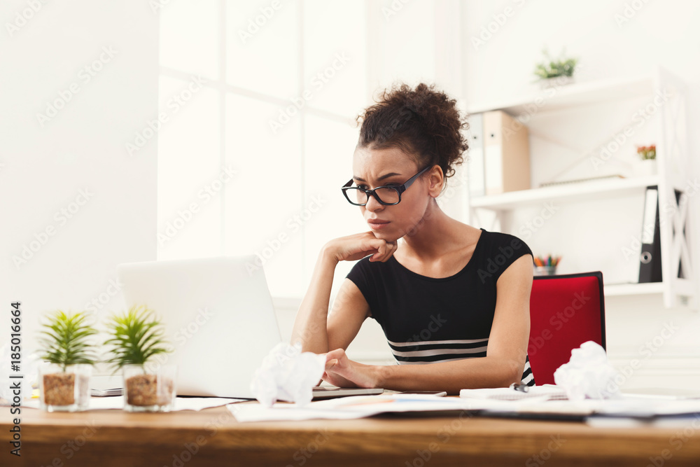 Serious business woman working on laptop at office Serious business woman working on laptop at office