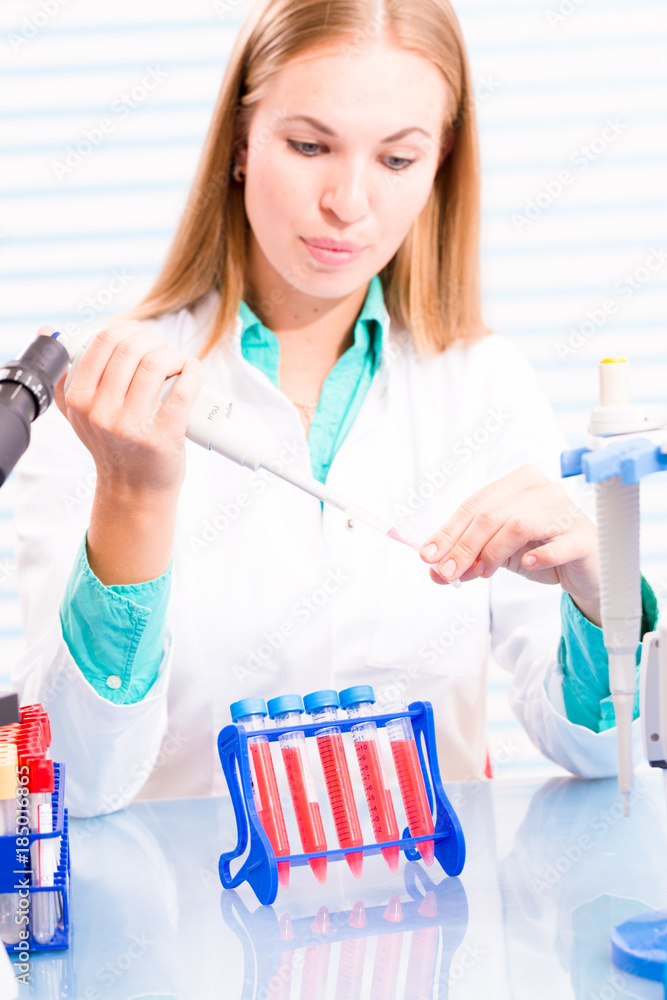 A nurse in a hospital laboratory tests a blood A nurse in a hospital laboratory tests a blood