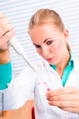 A nurse in a hospital laboratory tests a blood
