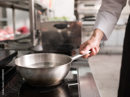 Pot and other kitchen utensils in professional restaurant. Chef's little helpers © Photodrive