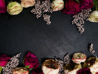 Gothic wedding flowers decor. Dark red or burgundy roses with silver adornment on black background. Bold, daring ,alternative ,and luxury reception party flower arrangement