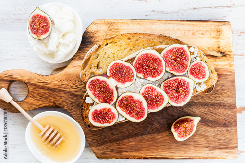 Healthy snack from sourdough bread toasts, figs and ricotta chee