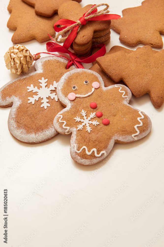 Smiling gingerbread man with other brown Christmas cookies