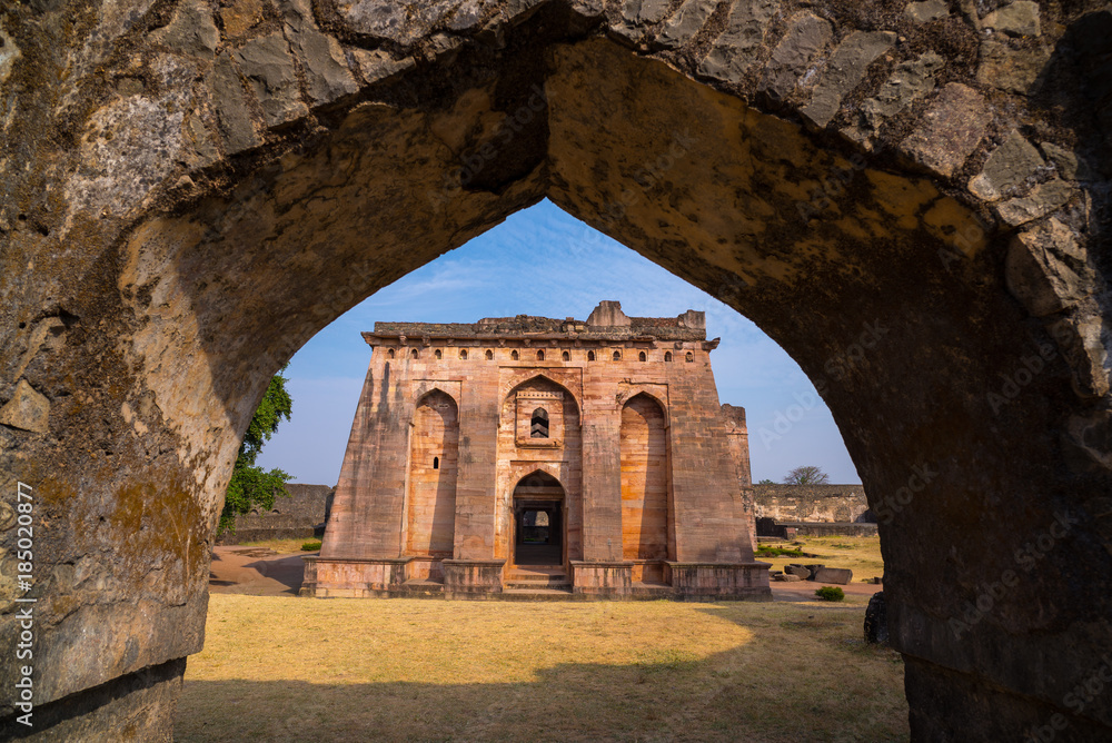 Mandu India, afghan ruins of islam kingdom, mosque monument and muslim tomb. View through door, Hindola Mahal.