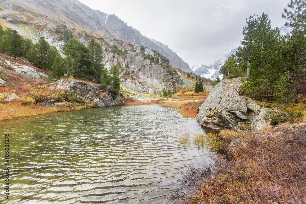 Small green lake. Altai Mountains autumn landscape Small green lake. Altai Mountains autumn landscape