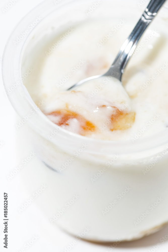 yoghurt in a jar with peach, vertical closeup yoghurt in a jar with peach, vertical closeup