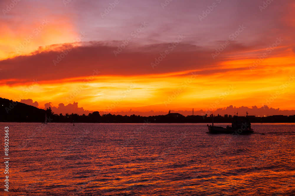 Beautiful Orange Sunset with Boat Silhouette in sea