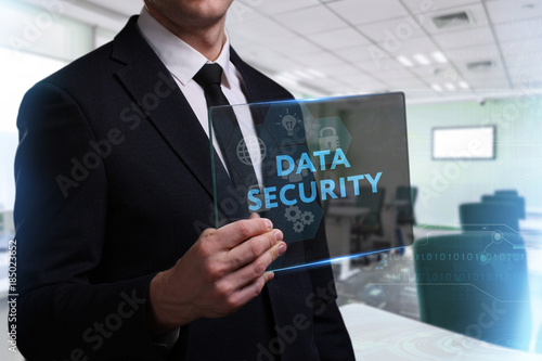 Business, Technology, Internet and network concept. Young businessman working on a virtual screen of the future and sees the inscription: Data security