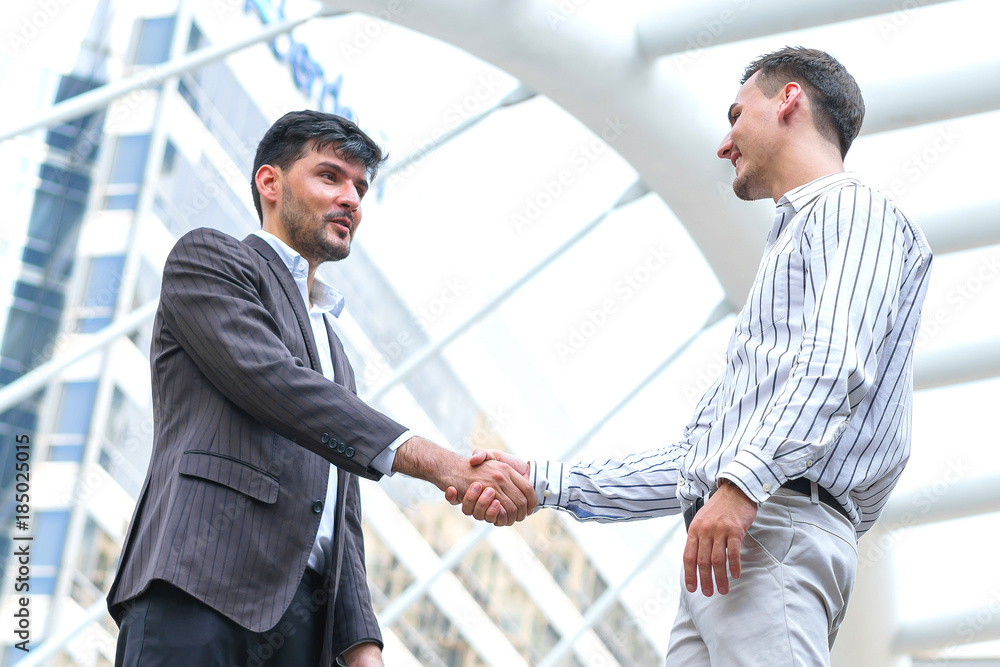 Two business man meeting partnership and shaking hands for deal success at site outdoors. Two business man meeting partnership and shaking hands for deal success at site outdoors.