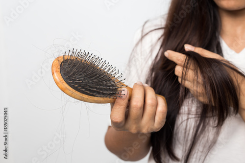 Bild auf Leinwand young woman worried about hair loss on a white background