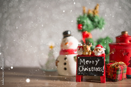 Christmas holiday background with Santa and decorations. Christmas landscape with gifts and snow. Merry christmas and happy new year greeting card with copy-space. © kamon_saejueng