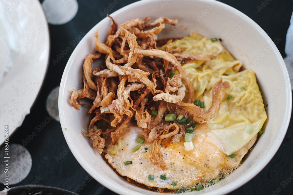 top view fusion noodle with wonton, egg and fried mushroom top view fusion noodle with wonton, egg and fried mushroom