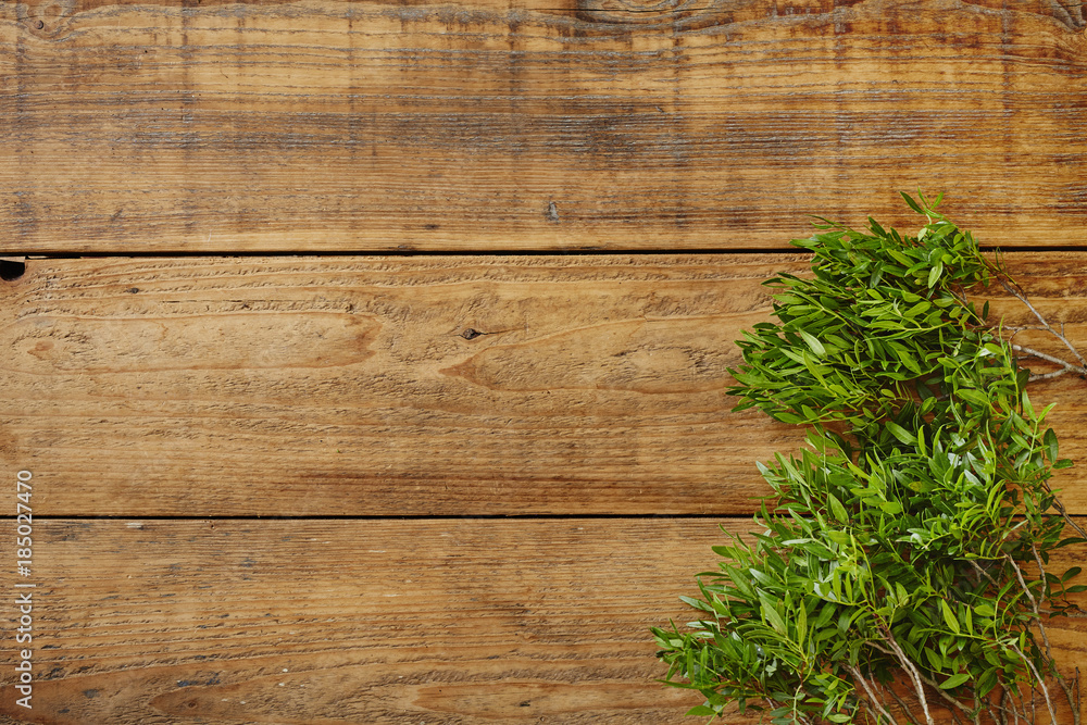 fresh green leaves on wooden surface fresh green leaves on wooden surface
