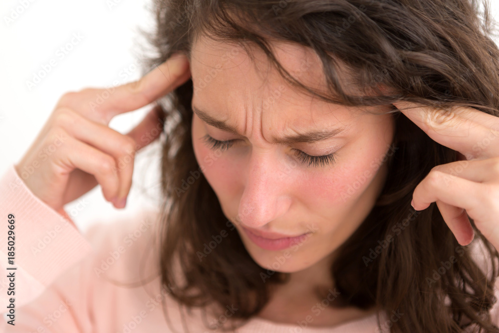 Young woman having a headache due to stress and anxiety - Burn out concept Young woman having a headache due to stress and anxiety - Burn out concept