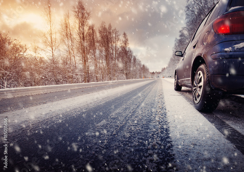 car on winter road in the morning