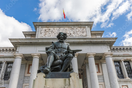  The main entrance to the Prado Museum and the bronze statue of Diego Velazquez in Madrid