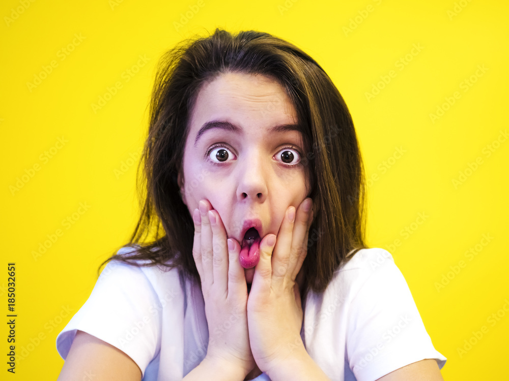 Portrait Of Surprised Girl Covering Her Mouth Looking At The Camera With Stunned And Shocked 