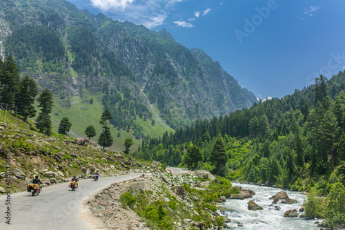 Tourists riding motorbikes in Himalayan mountains on Srinagar - Kargil road in Jammu and Kashmir state, India. photo