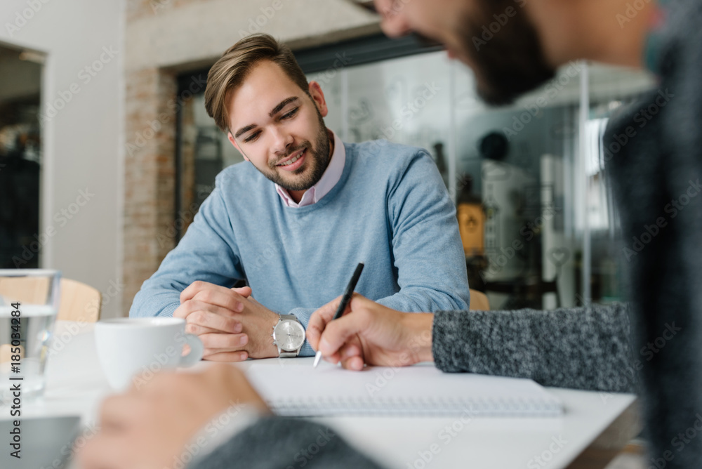 Checking human resource questionnaire at a job interview with a job candidate Checking human resource questionnaire at a job interview with a job candidate