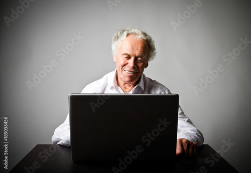 Old man using a laptop